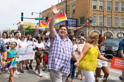 Governor J.B. Pritzker waving and his wife